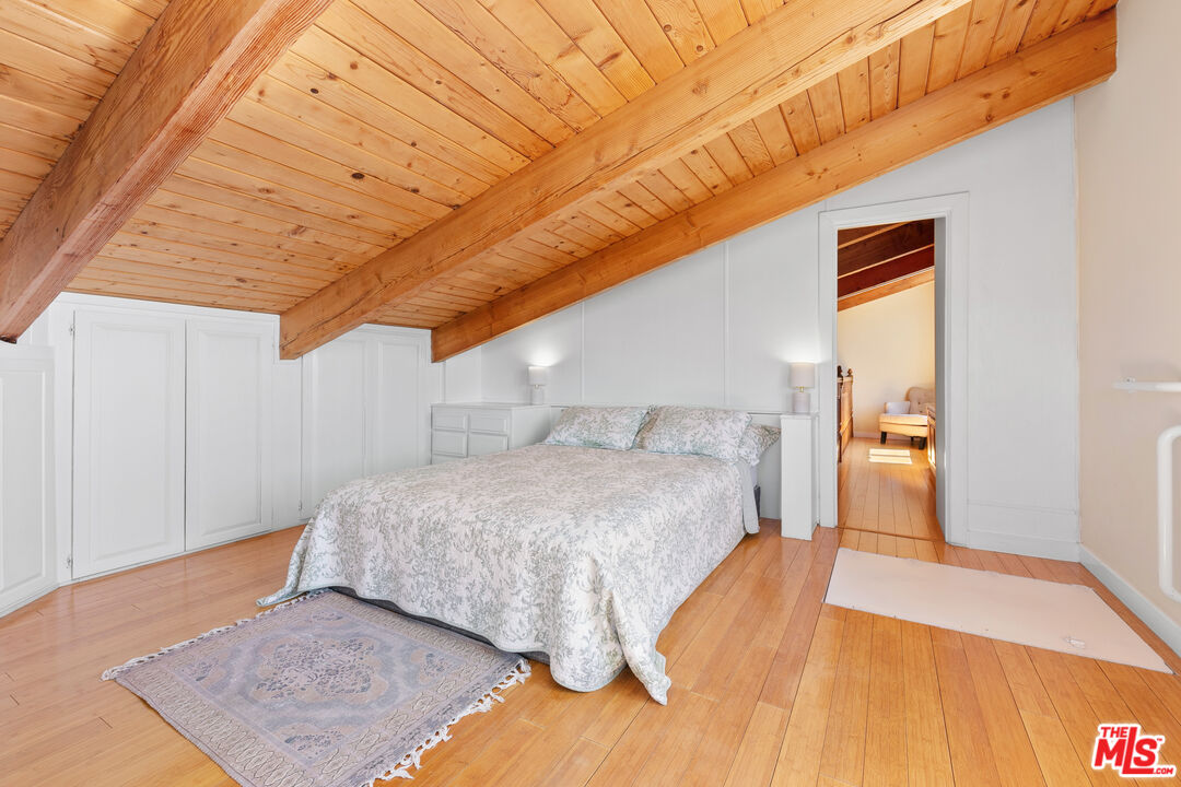 2302 Latigo Canyon Road Malibu, CA 90265 - Photo 18 of 30 a bedroom with a bed and wooden floor