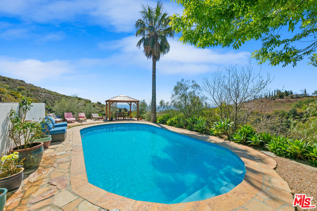 2302 Latigo Canyon Road Malibu, CA 90265 - Photo 2 of 30 a view of a swimming pool with a patio