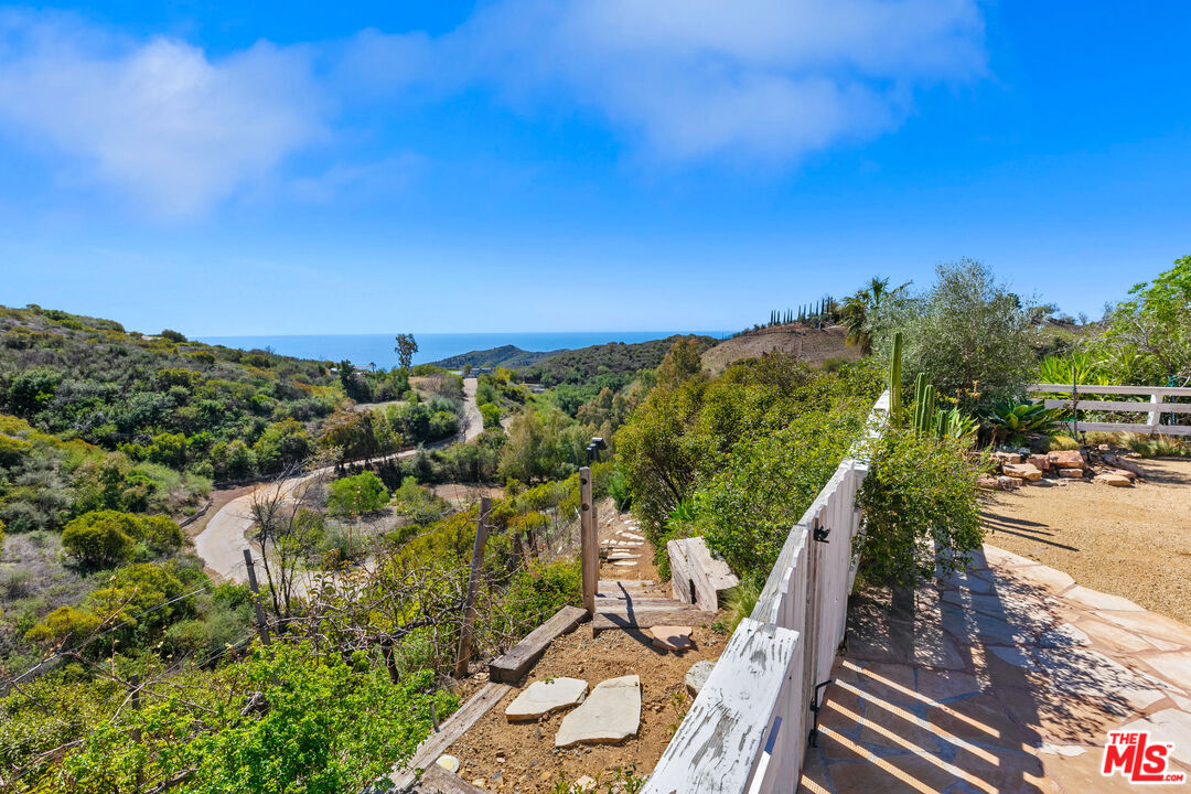 2302 Latigo Canyon Road Malibu, CA 90265 - Photo 21 of 30 a view of a balcony with wooden floor and outdoor space