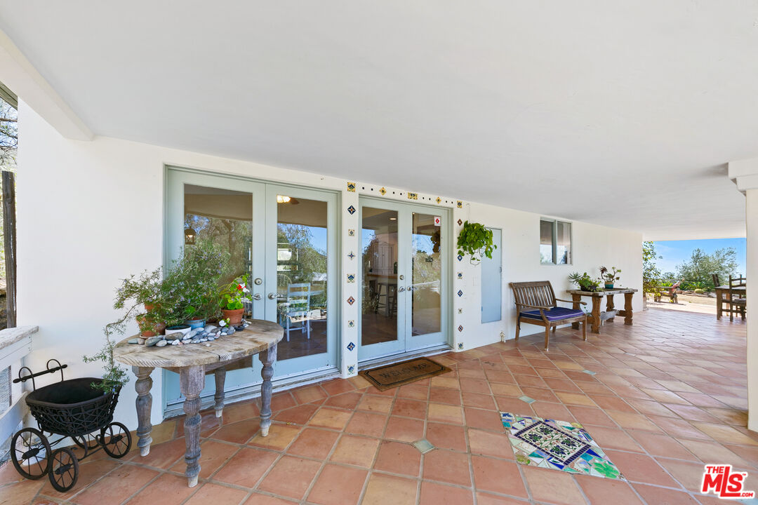 2302 Latigo Canyon Road Malibu, CA 90265 - Photo 24 of 30 a living room with furniture and a potted plant