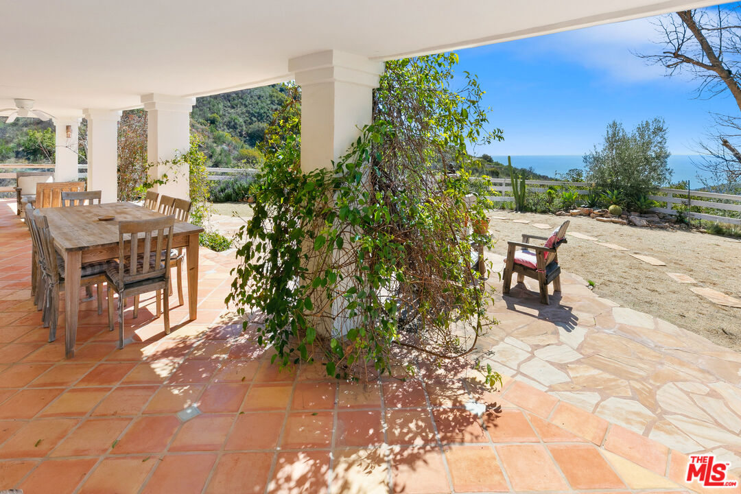 2302 Latigo Canyon Road Malibu, CA 90265 - Photo 25 of 30 a view of a patio with table and chairs and potted plants