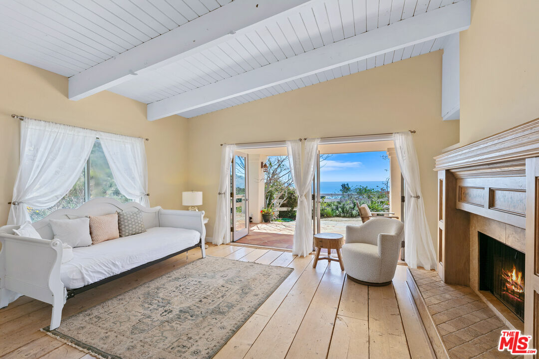 2302 Latigo Canyon Road Malibu, CA 90265 - Photo 5 of 30 a living room with furniture and a fireplace
