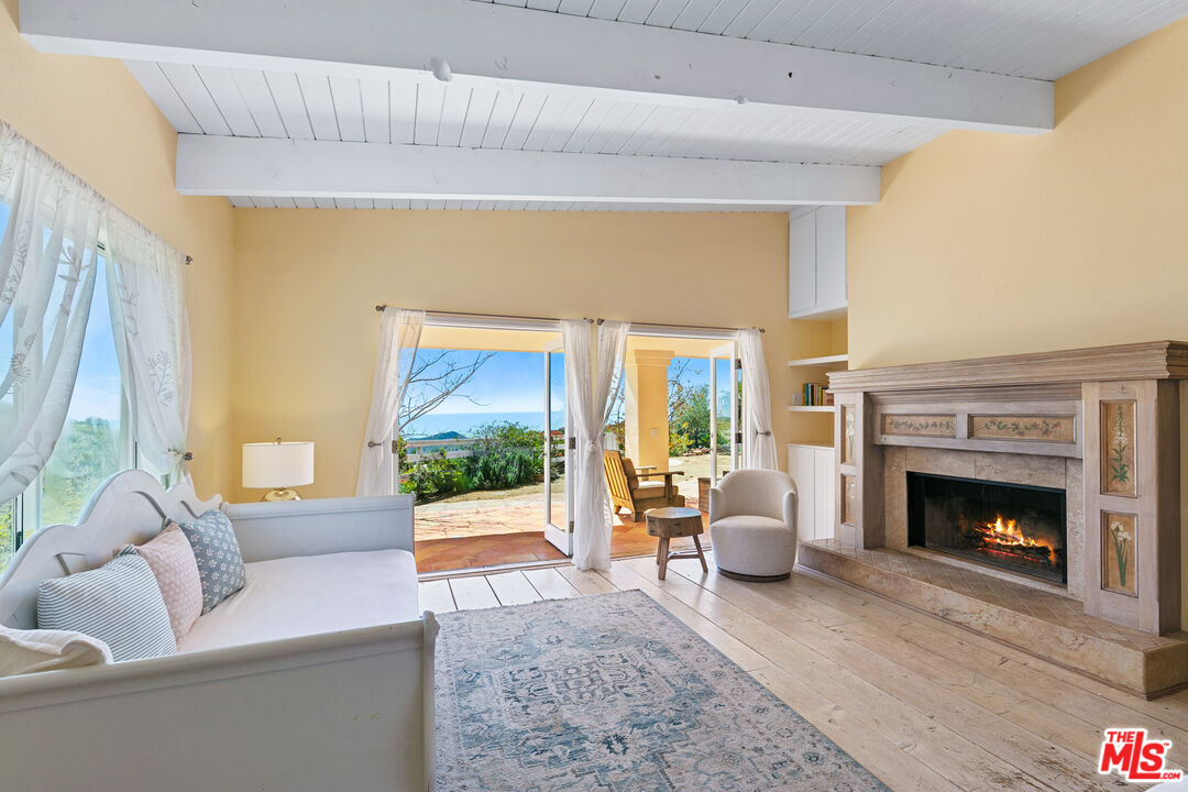 2302 Latigo Canyon Road Malibu, CA 90265 - Photo 6 of 30 a living room with furniture and a fireplace