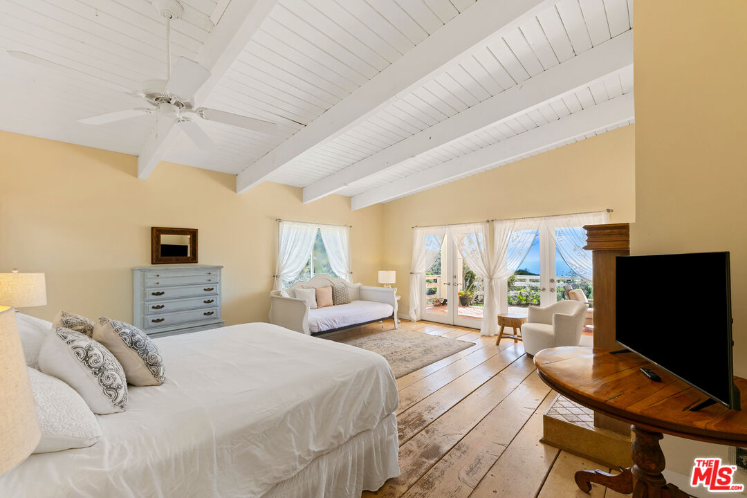 2302 Latigo Canyon Road Malibu, CA 90265 - Photo 7 of 30 a bedroom with a bed and a flat screen tv