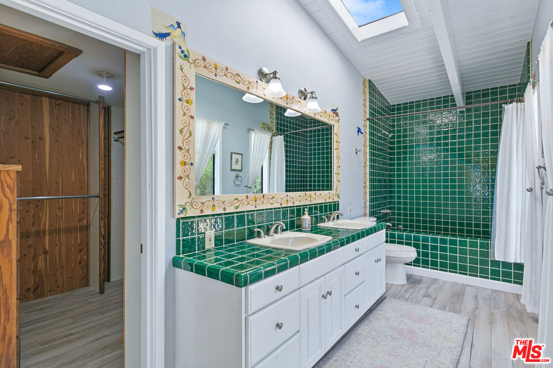2302 Latigo Canyon Road Malibu, CA 90265 - Photo 9 of 30 a bathroom with a granite countertop sink and a mirror