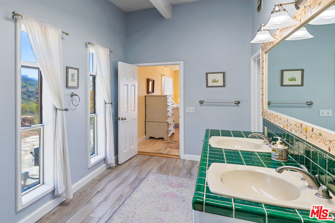 2302 Latigo Canyon Road Malibu, CA 90265 - Photo 10 of 30 a bathroom with a sink a mirror and a shower