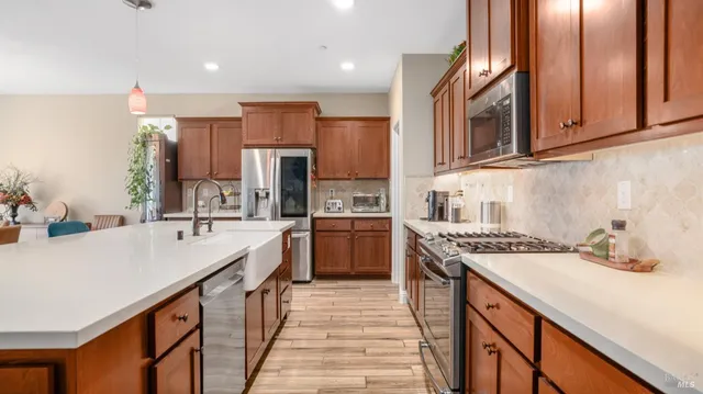 a kitchen with a sink stove and refrigerator