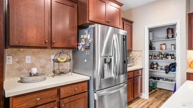 a kitchen with stainless steel appliances a refrigerator and a sink