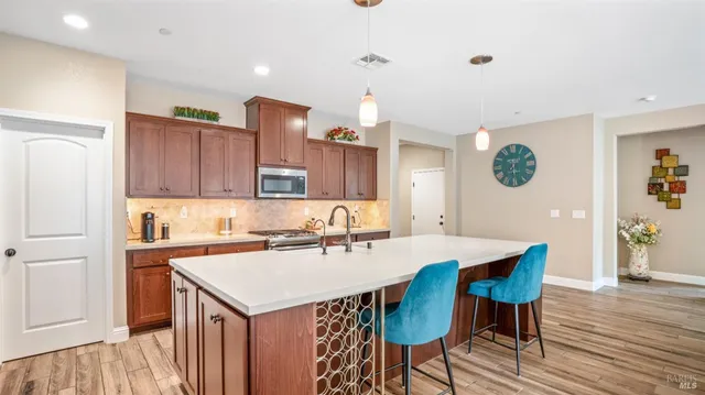 a kitchen with a sink a cabinets and chairs