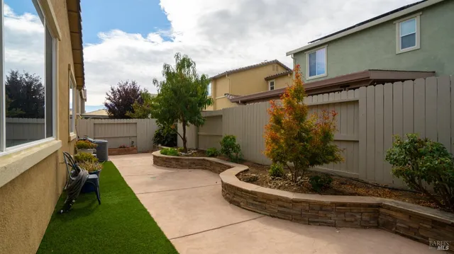 a living room with a couch and a potted plant