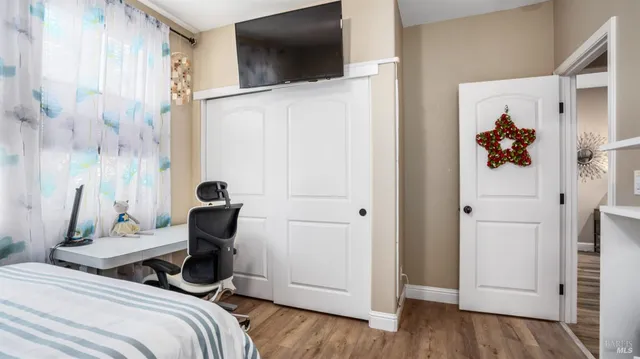 a bedroom with a bed and a flat screen tv