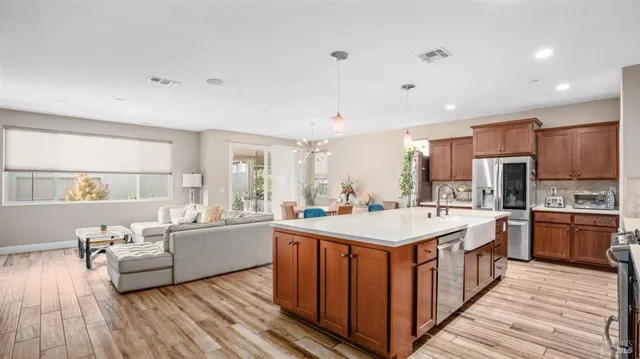 a large white kitchen with a large counter top appliances and cabinets
