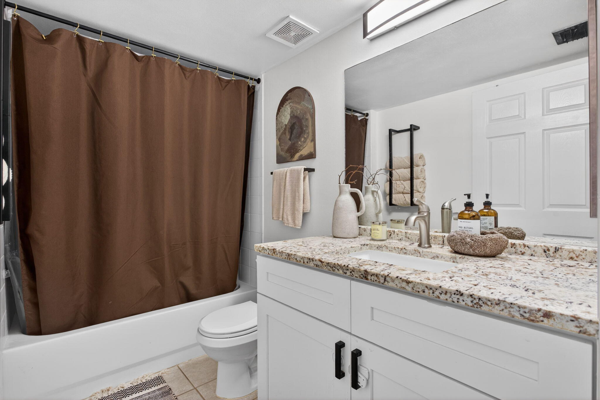 5011 Wiles Road, Unit 104 Coconut Creek, FL 33073 - Photo 19 of 43 a bathroom with a granite countertop sink toilet and mirror