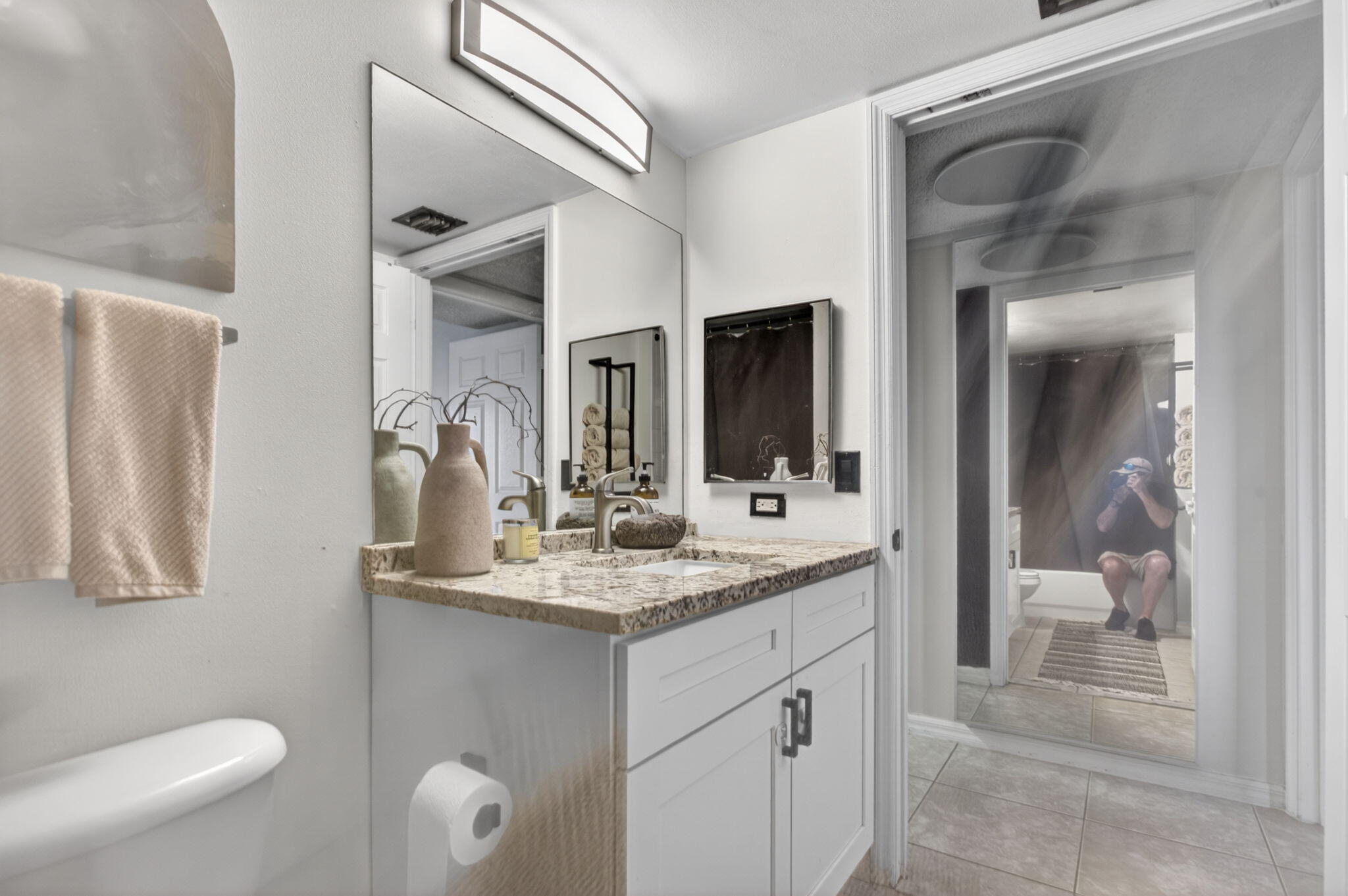 5011 Wiles Road, Unit 104 Coconut Creek, FL 33073 - Photo 20 of 43 a bathroom with a granite countertop sink mirror and toilet