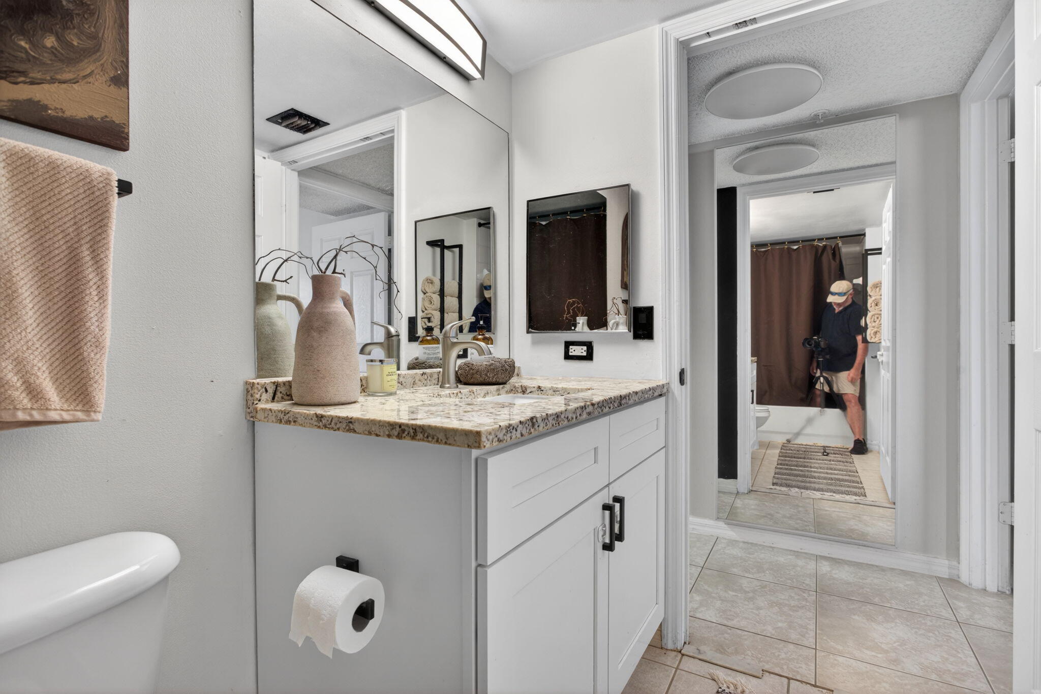 5011 Wiles Road, Unit 104 Coconut Creek, FL 33073 - Photo 21 of 43 a bathroom with a granite countertop sink and a mirror