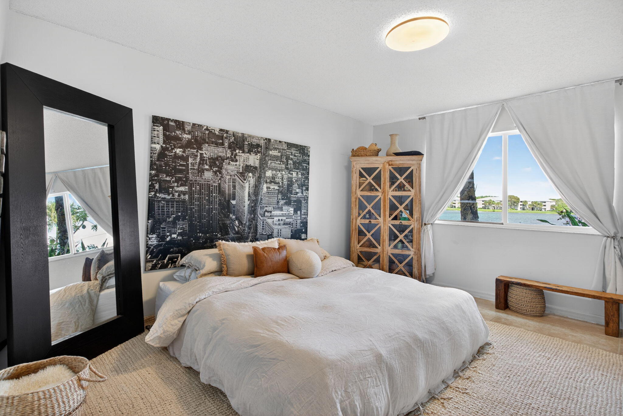 5011 Wiles Road, Unit 104 Coconut Creek, FL 33073 - Photo 23 of 43 a bedroom with a large bed and a window