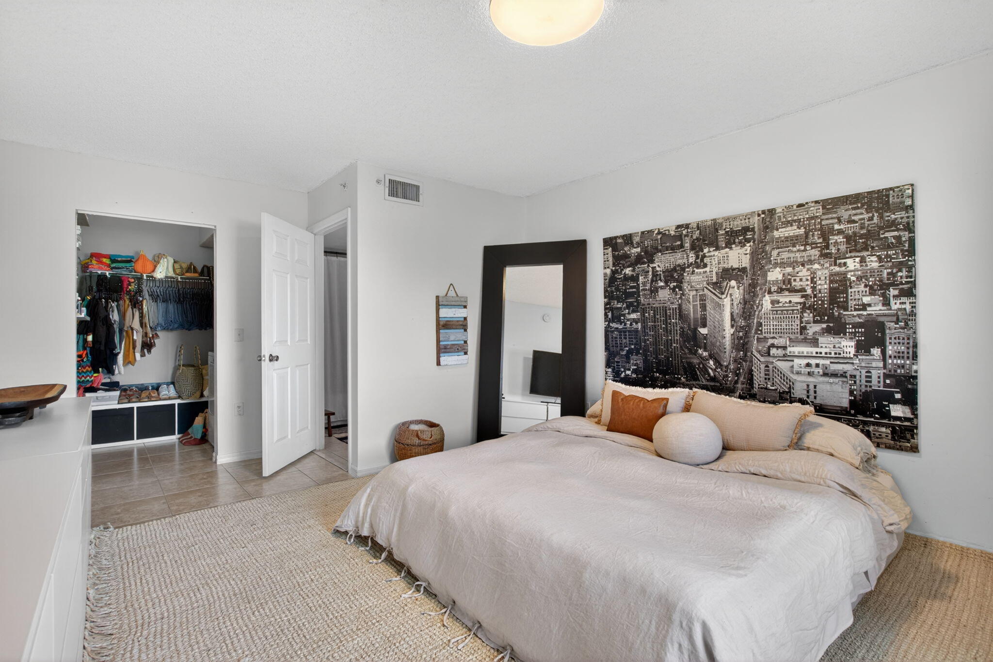 5011 Wiles Road, Unit 104 Coconut Creek, FL 33073 - Photo 24 of 43 a bedroom with a large bed and a large window