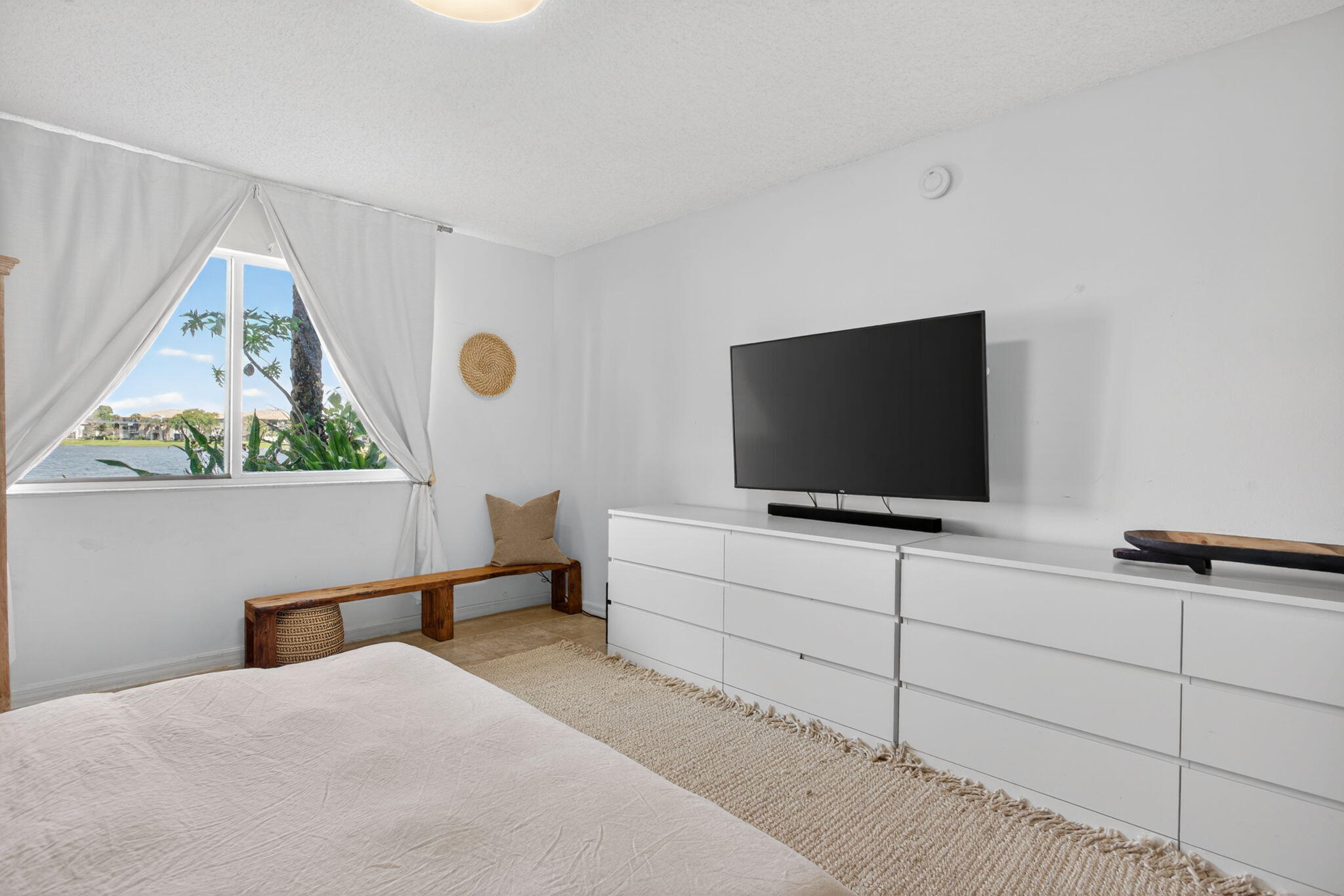 5011 Wiles Road, Unit 104 Coconut Creek, FL 33073 - Photo 25 of 43 a living room with furniture and a flat screen tv