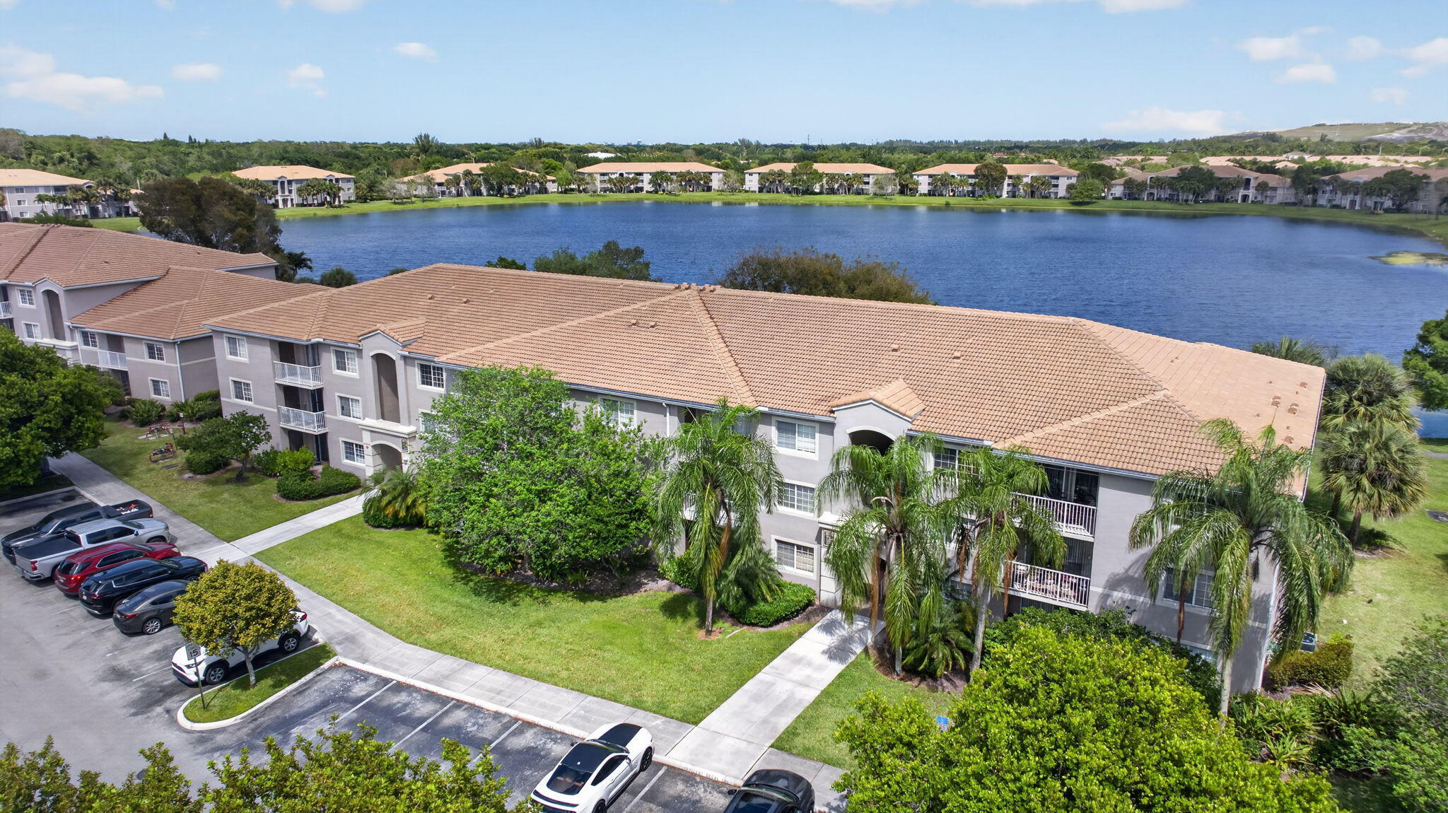 5011 Wiles Road, Unit 104 Coconut Creek, FL 33073 - Photo 30 of 43 an aerial view of a house with a garden and lake view