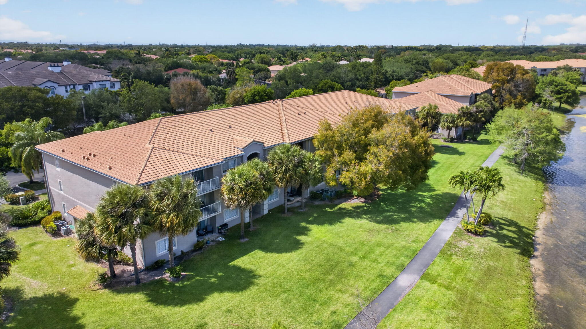 5011 Wiles Road, Unit 104 Coconut Creek, FL 33073 - Photo 31 of 43 an aerial view of residential houses with outdoor space and trees