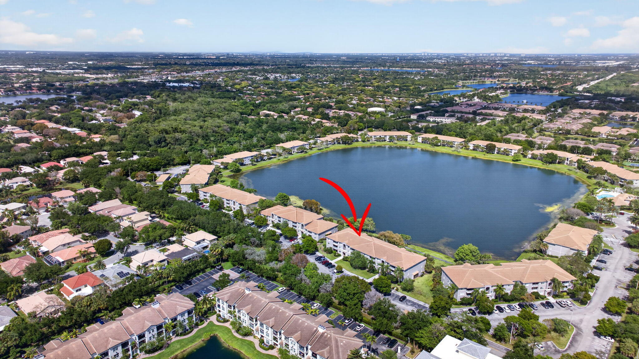 5011 Wiles Road, Unit 104 Coconut Creek, FL 33073 - Photo 40 of 43 an aerial view of a houses with a lake