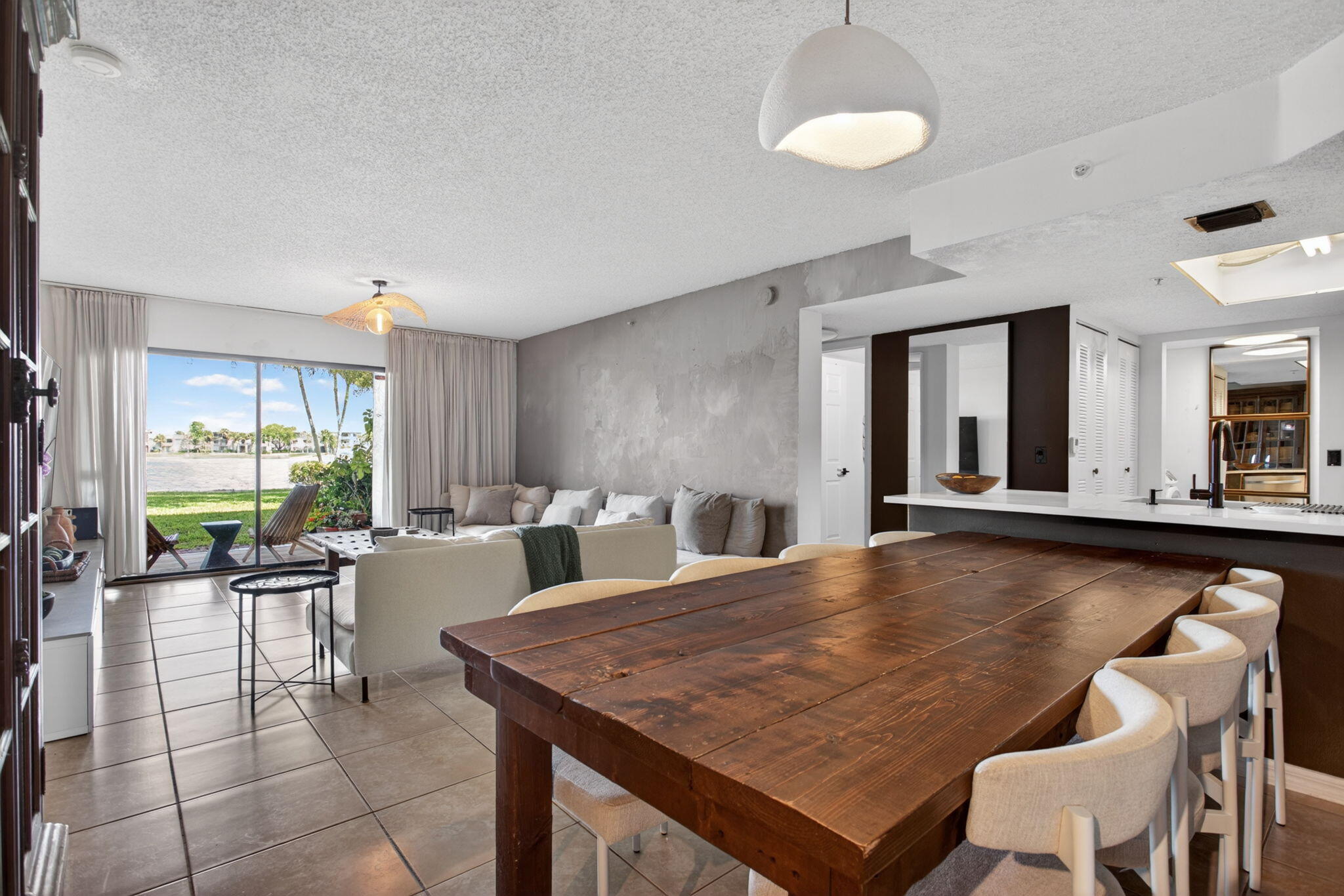 5011 Wiles Road, Unit 104 Coconut Creek, FL 33073 - Photo 8 of 43 a dining hall with furniture a large window and a rug