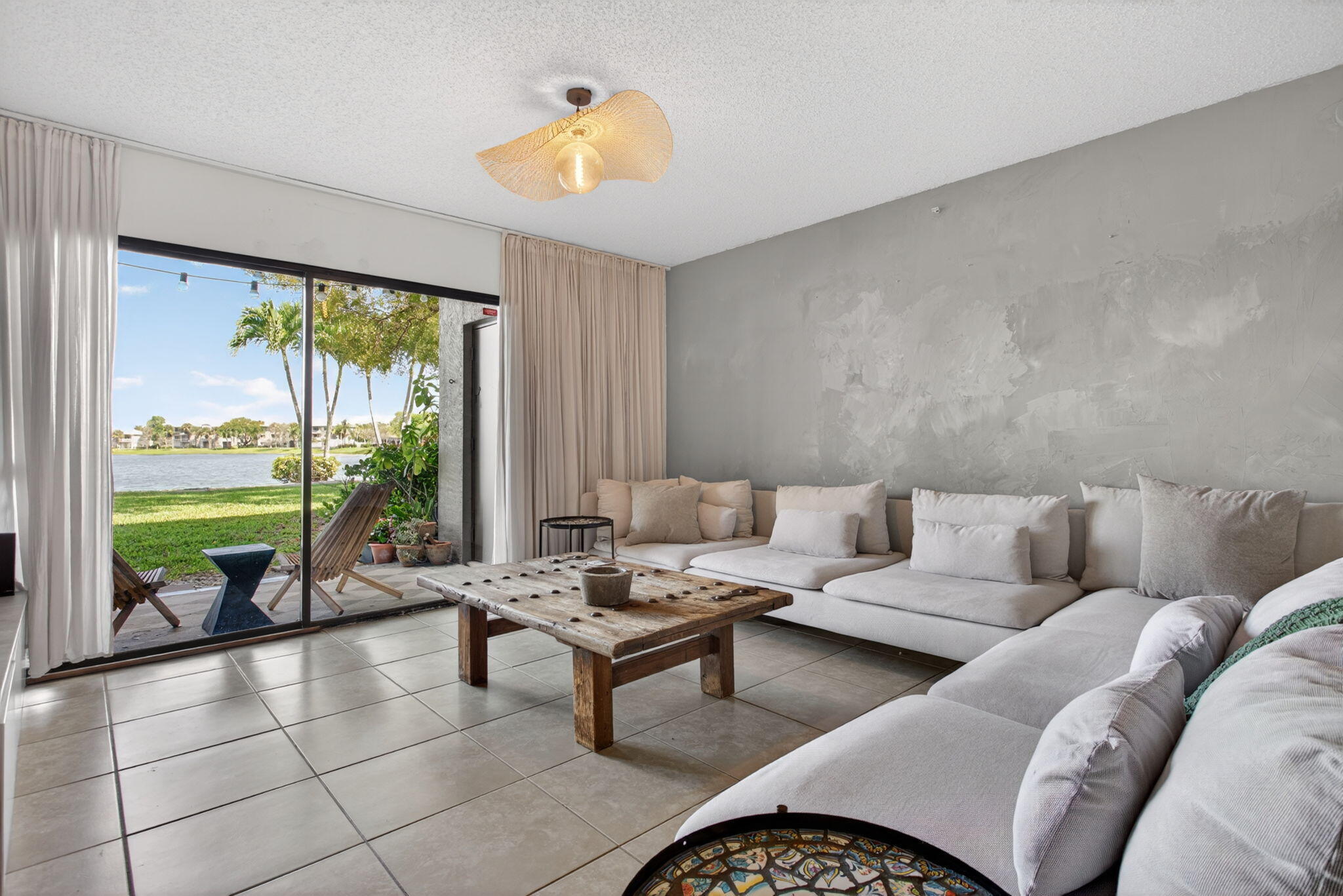 5011 Wiles Road, Unit 104 Coconut Creek, FL 33073 - Photo 9 of 43 a living room with furniture and a large window