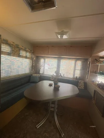 a dining room with table tennis and windows