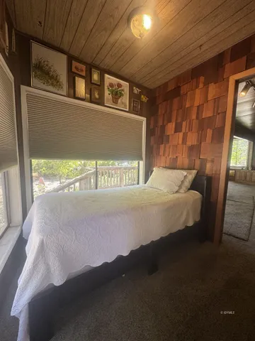 a bed sitting in a room next to a window