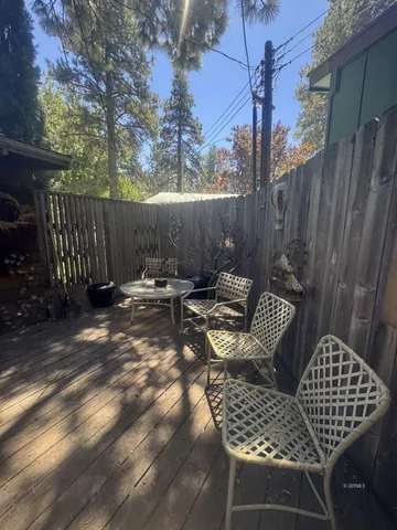 a view of balcony with wooden floor and outdoor seating
