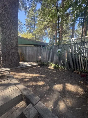 a view of outdoor space with wooden fence