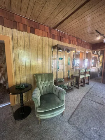 a living room with furniture and a painting