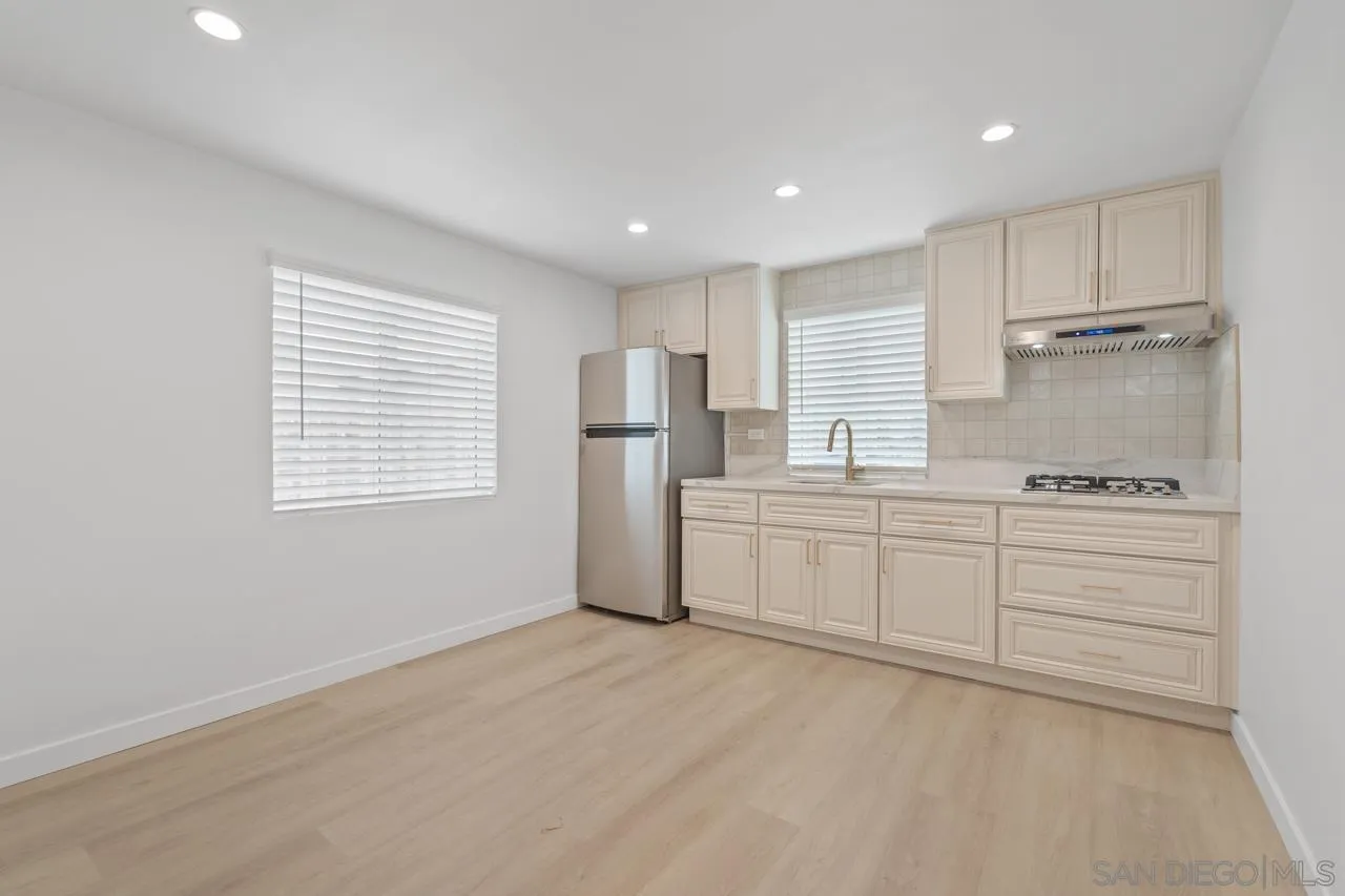 1195 Georgia Street, Unit B Imperial Beach, CA 91932 - Photo 1 of 17 a kitchen with granite countertop white cabinets and white appliances