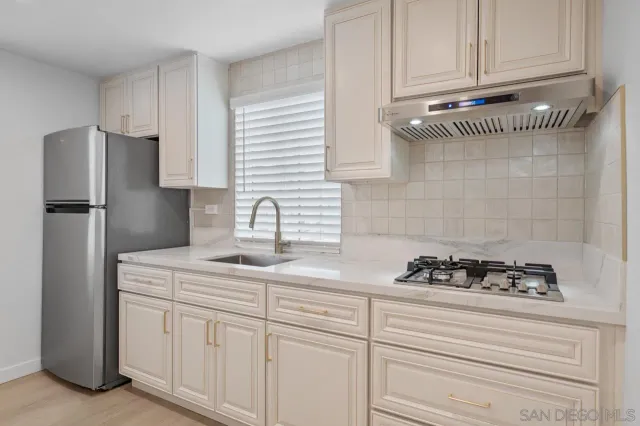 a kitchen with appliances cabinets and a counter space