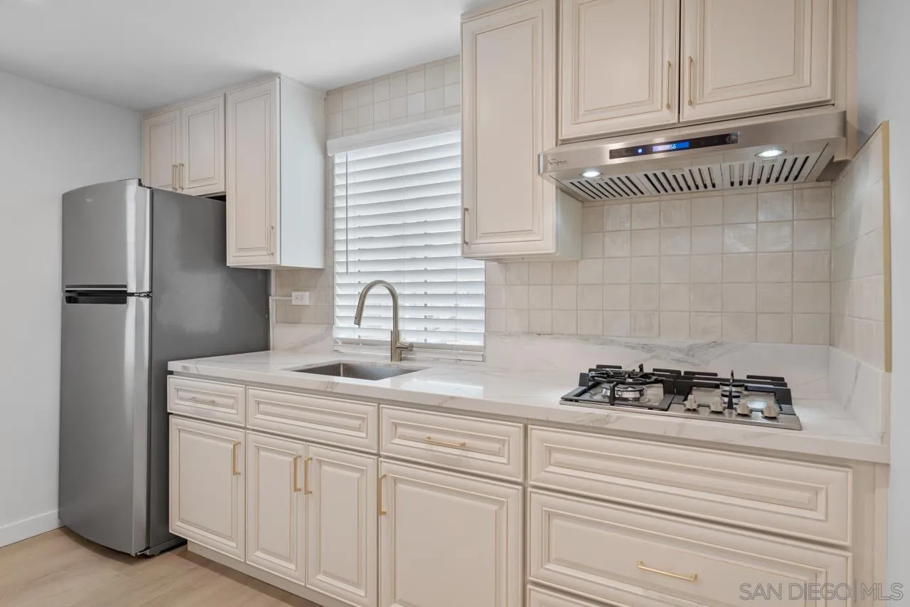 1195 Georgia Street, Unit B Imperial Beach, CA 91932 - Photo 2 of 17 a kitchen with appliances cabinets and a counter space