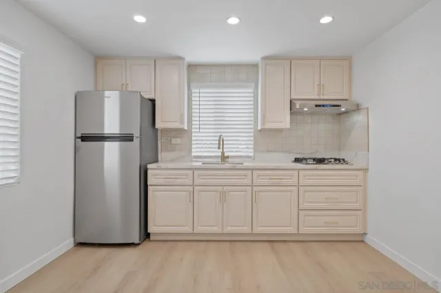 a kitchen with cabinets and stainless steel appliances