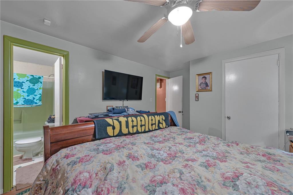 565 Upper Middletown Road Smock, PA 15480 - Photo 13 of 25 a bedroom with a bed and a flat screen television