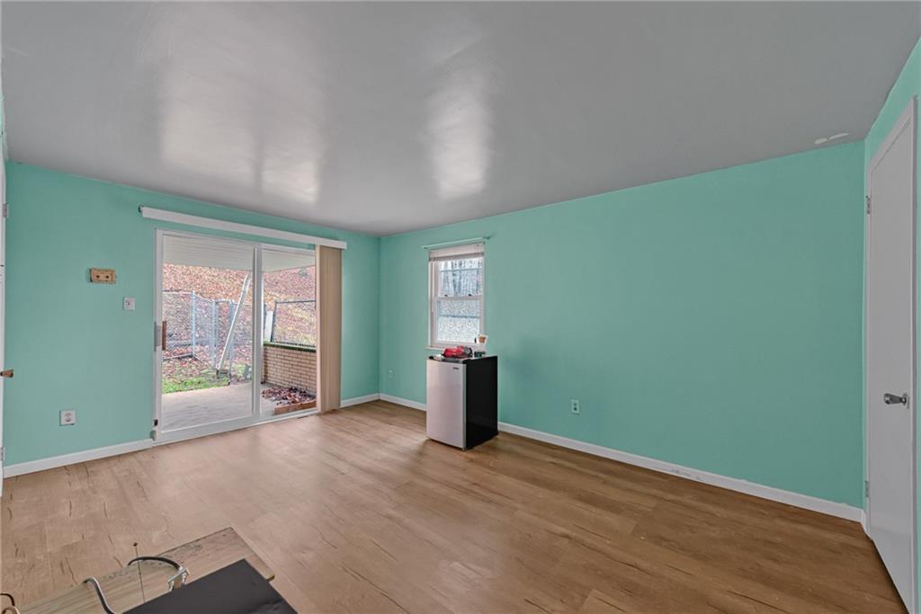 565 Upper Middletown Road Smock, PA 15480 - Photo 15 of 25 an empty room with wooden floor and windows