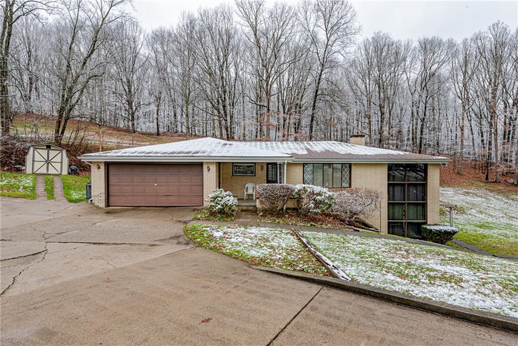 565 Upper Middletown Road Smock, PA 15480 - Photo 2 of 25 a front view of house with yard space and trees in the background