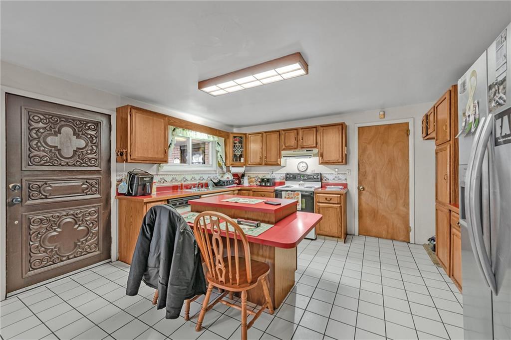 565 Upper Middletown Road Smock, PA 15480 - Photo 6 of 25 a kitchen with stainless steel appliances granite countertop a refrigerator and a stove top oven
