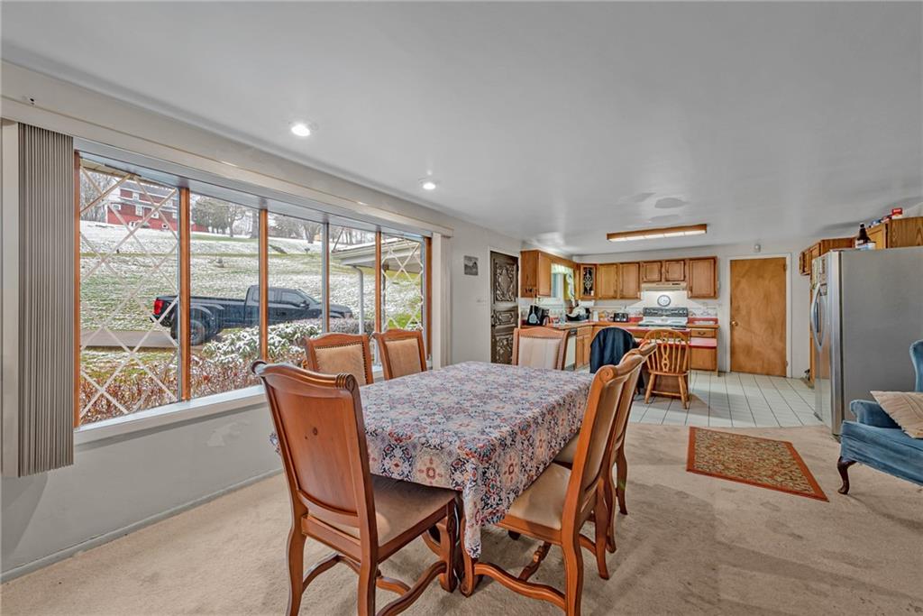 565 Upper Middletown Road Smock, PA 15480 - Photo 9 of 25 a dining room with furniture large windows and wooden floor