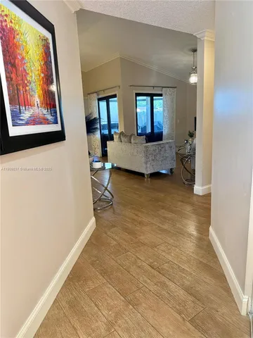 a living room with furniture a dining table and a flat screen tv