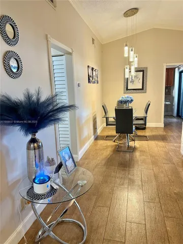 a view of a room with table and chairs