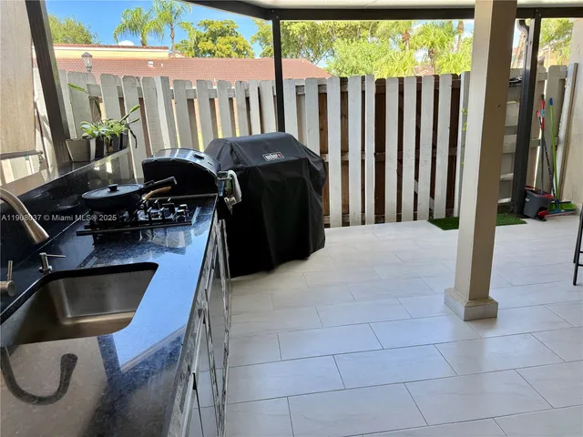a living room with furniture and flowers