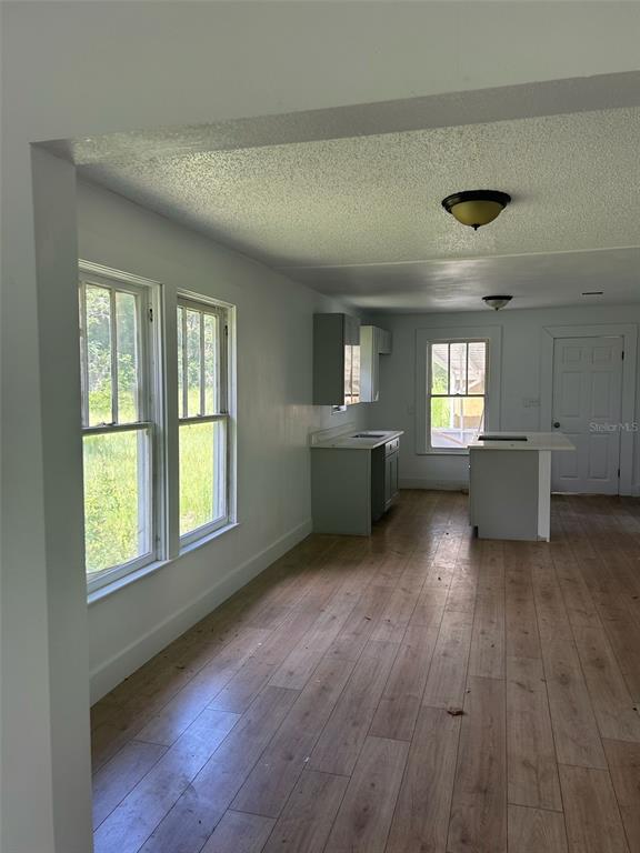 1059 South Moody Road Palatka, FL 32177 - Photo 5 of 12 a view of an empty room with window and wooden floor