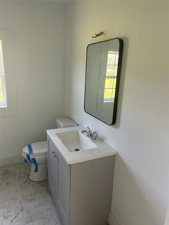 1059 South Moody Road Palatka, FL 32177 - Photo 9 of 12 a bathroom with a toilet sink and mirror