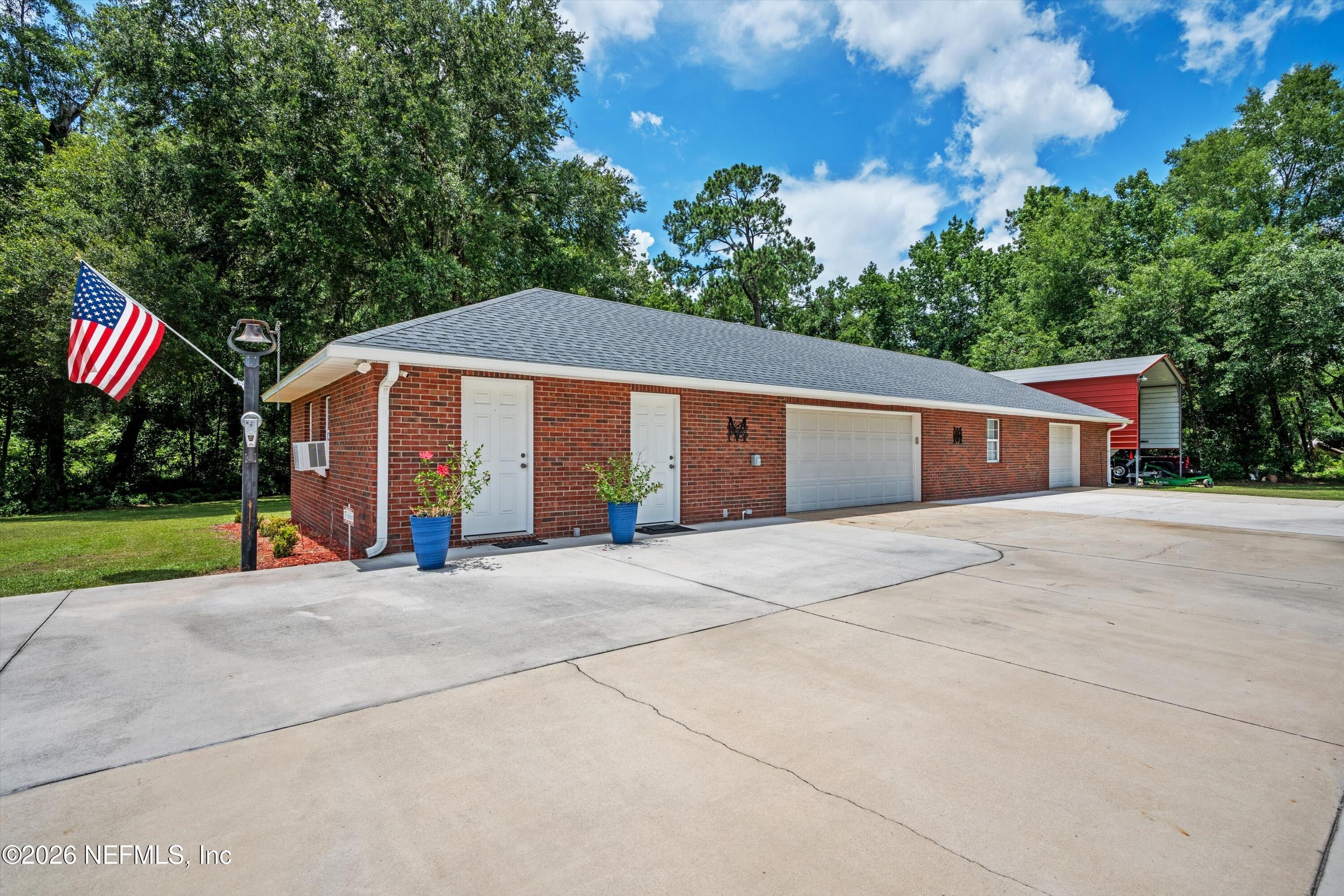 5566 Don Manuel Road Elkton, FL 32033 - Photo 40 of 47 a view of a house with a yard and potted plants