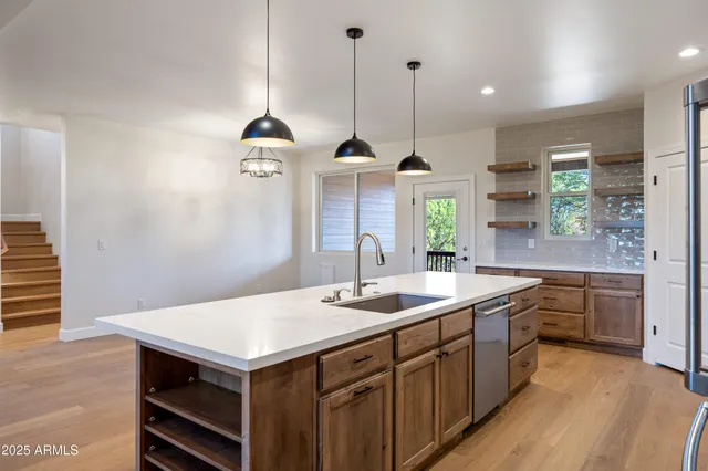 a kitchen with stainless steel appliances a stove a microwave and a refrigerator
