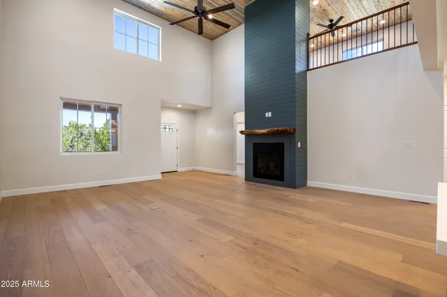 a large kitchen with kitchen island a large counter top space a sink stainless steel appliances and cabinets