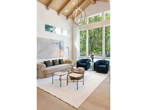 a living room with furniture a fireplace and a table